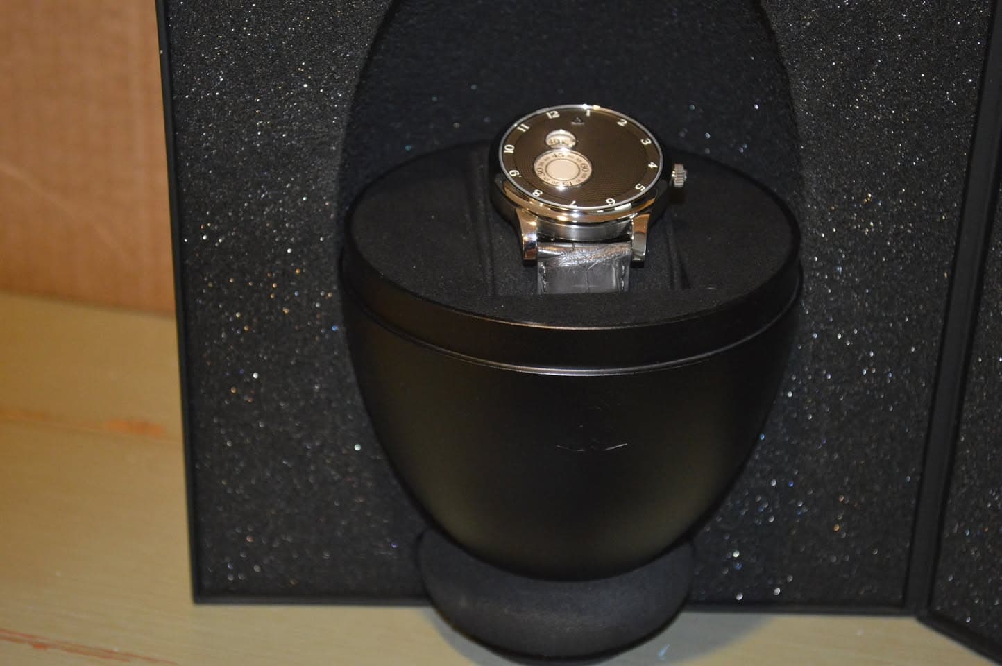 May be an image of wrist watch, speaker and fragrance