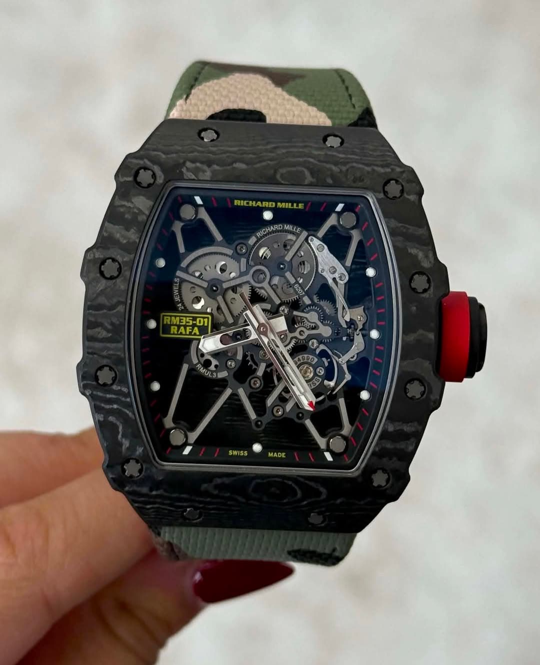 May be an image of wrist watch and text that says 'RICHA RICHARDMIL RICHARDMILLE WIL ICHAROMILLE MILE M35-01 RAFA Pm SWISS MADE'
