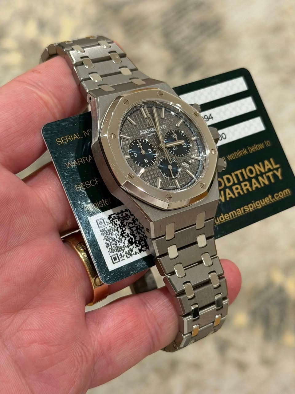 May be an image of wrist watch and text that says '94 ALDEMARS XEL AOTOBO 7. 00 ODITIONAL VARRANTY udemarspiguet PARRANTY com אאיה ロを部ん'