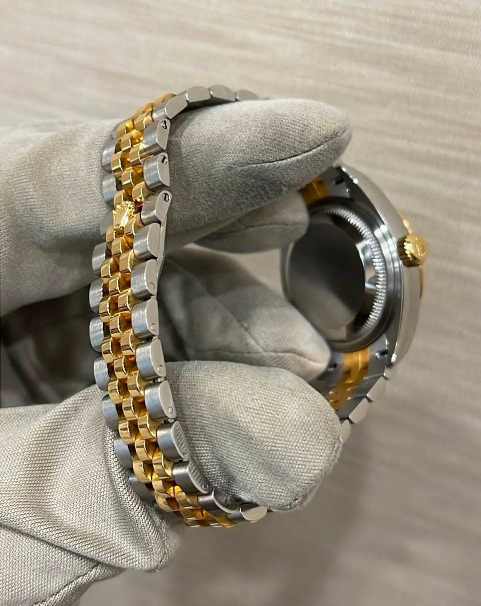 May be an image of wrist watch and jewelry