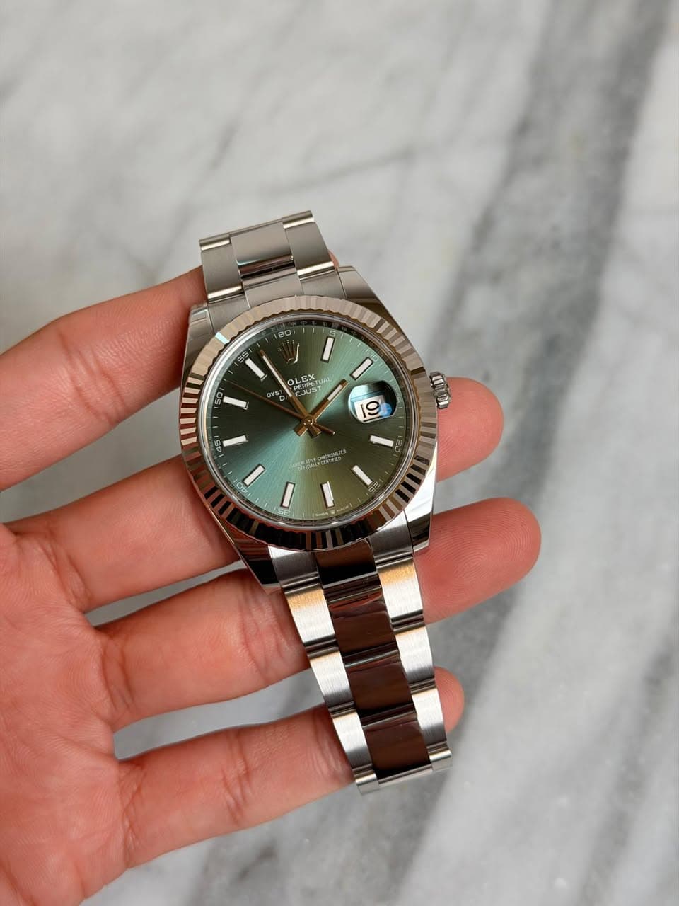 May be an image of wrist watch and text