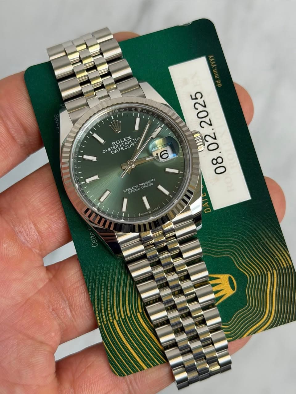 May be an image of wrist watch and text