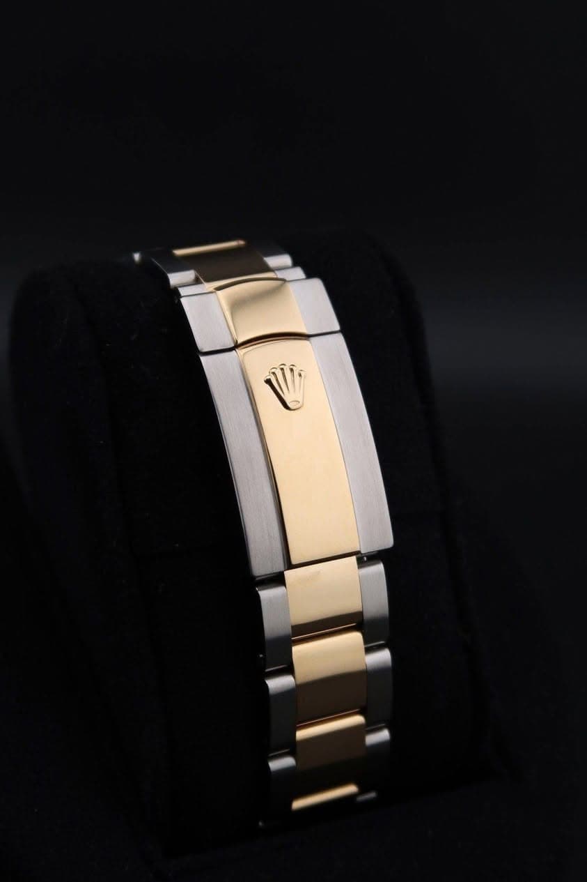 May be an image of jewelry, wrist watch and text