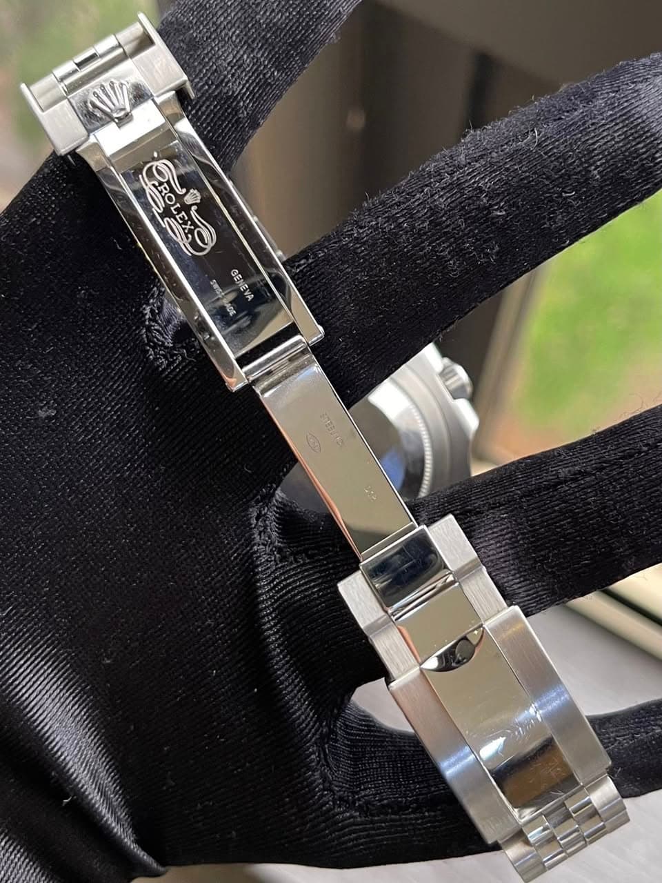 May be an image of digital watch, cufflinks and text
