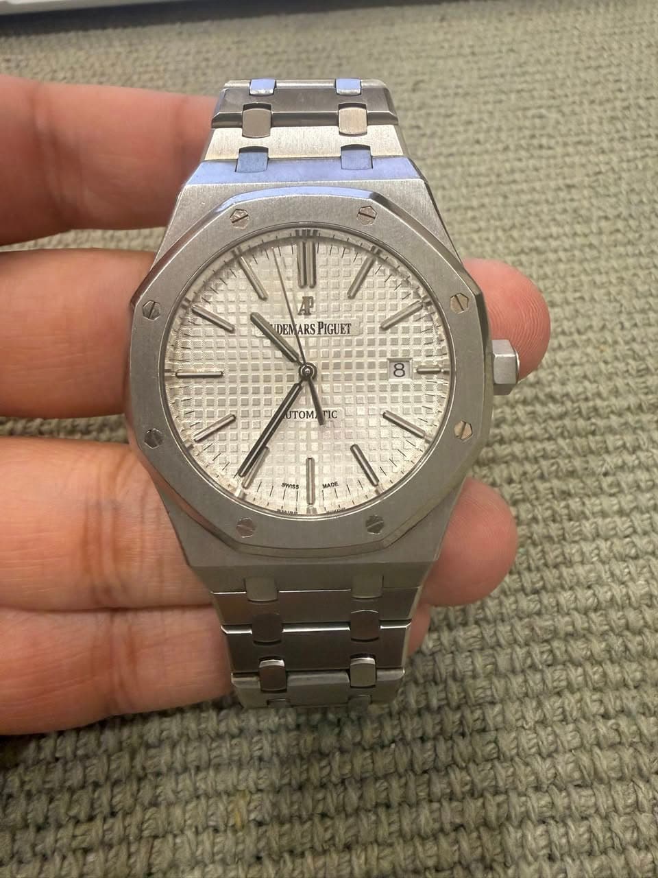 May be an image of wrist watch and text