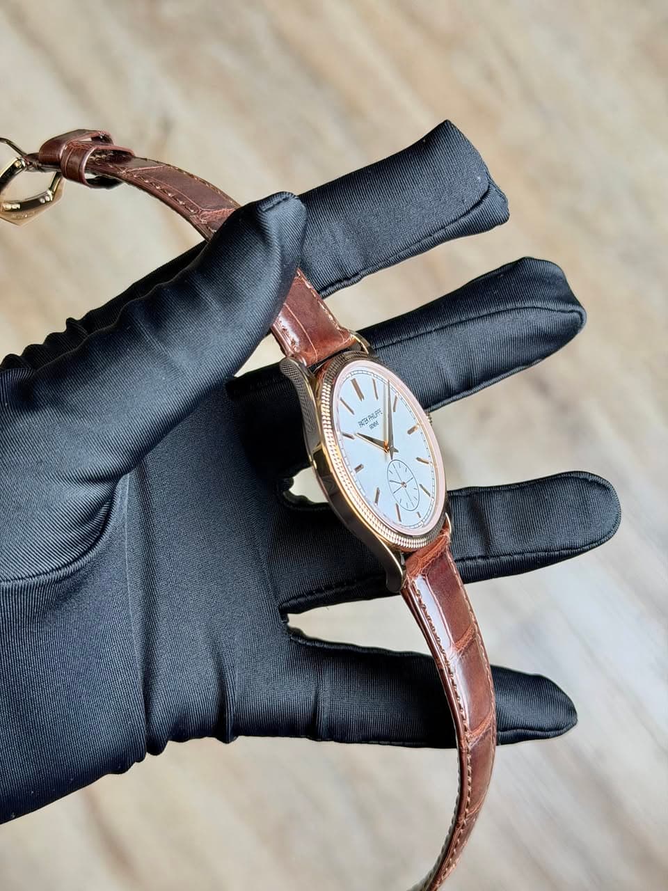 May be an image of leather, wrist watch and text