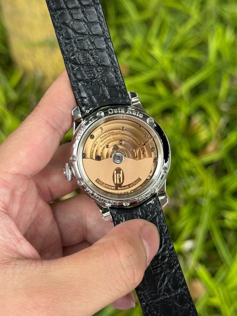 May be an image of wrist watch, leather and text