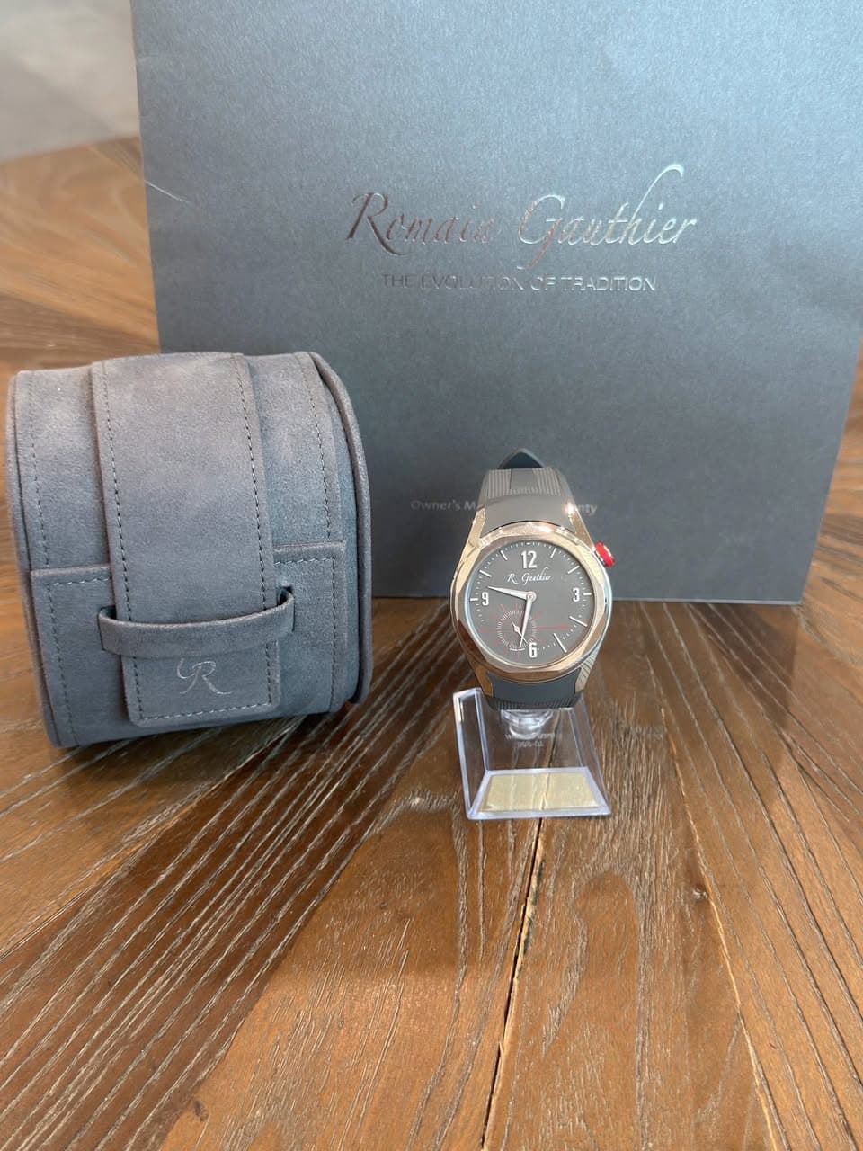 May be an image of leather, wrist watch and text