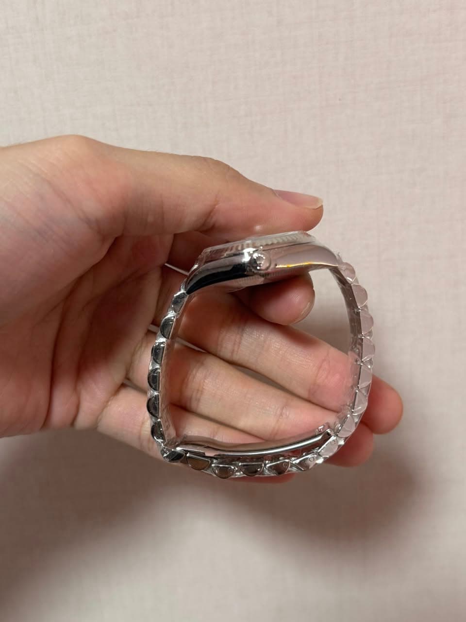 May be an image of wrist watch and jewelry
