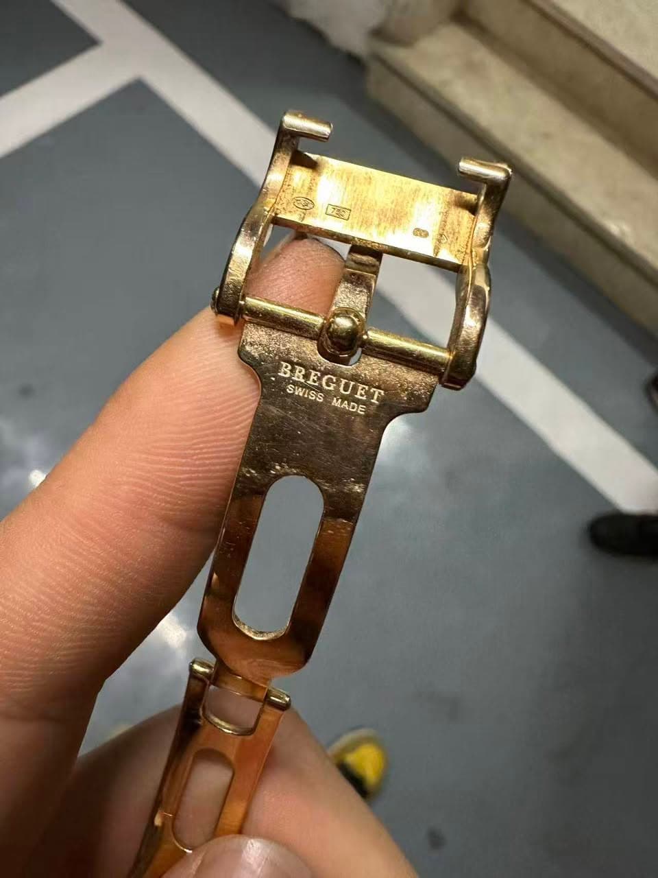 May be an image of wrist watch and brass