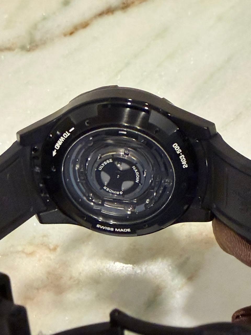 May be an image of digital watch and text that says 'ONIMOI ONMOL- 1 - 11 CNM ULYSSE - NINAON OE RONIS 1 SWISS BWISSMADE MADE'