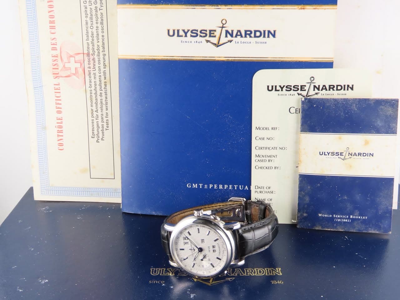 May be an image of wrist watch and text that says 'ULYSSE NARDIN SINCE 1846 LOCLE SUISSE espiral oscilata DES ante lateur a balance UISSE + OSCH Unrenel sprung bracelet with…