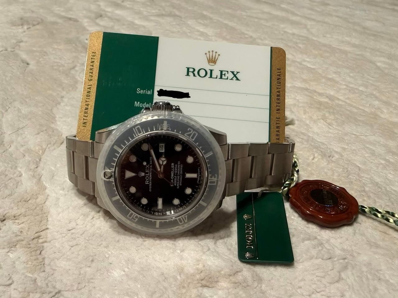May be an image of wrist watch and text that says 'GUARANTEE Serial ial Ser ROLEX Model 10'
