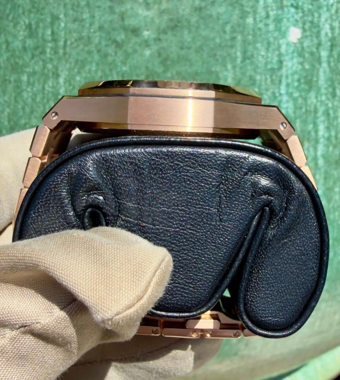 May be an image of saddle-stitched leather, wrist watch, leather wallet and leather