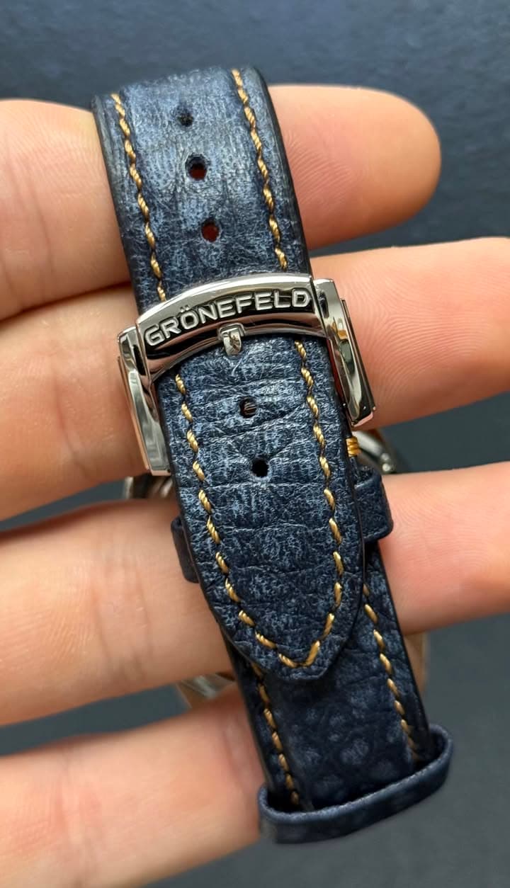 May be an image of saddle-stitched leather, wrist watch and text
