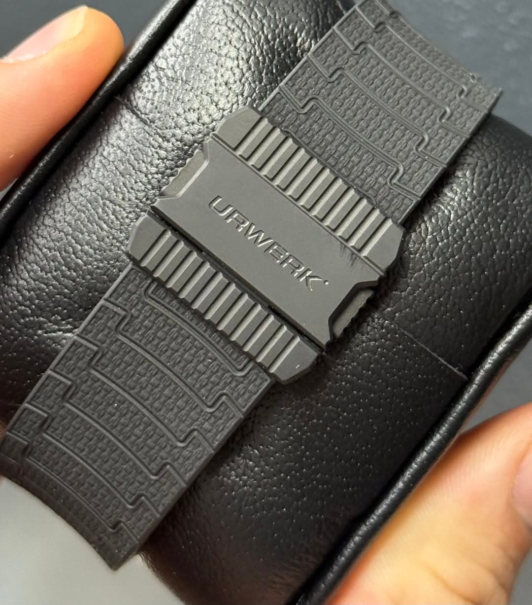 May be an image of saddle-stitched leather, leather wallet, wrist watch, leather and text
