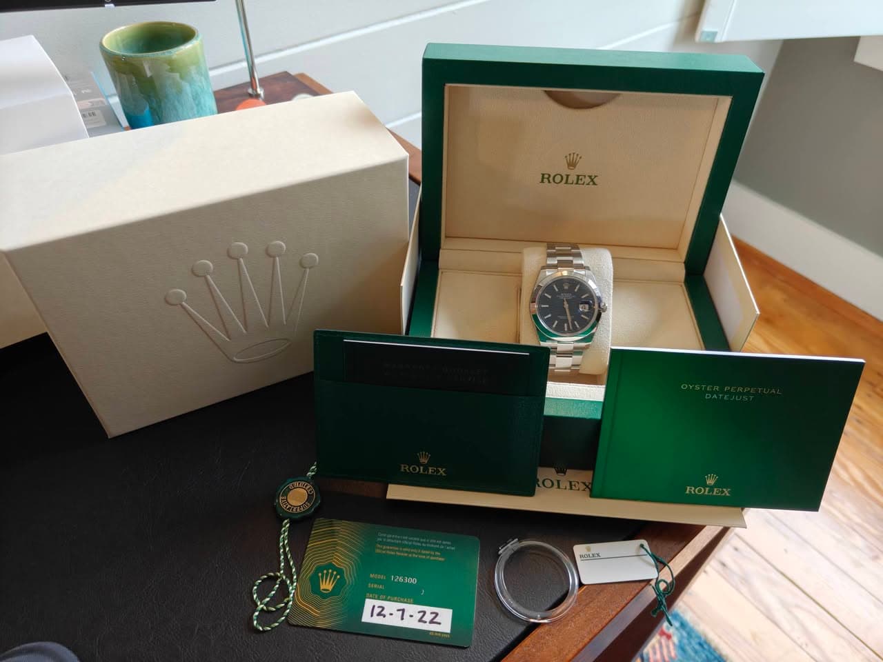 May be an image of wrist watch and text that says '1li- ROLEX P W ROL 125300 WOARS ኢዴ 12.1-2Z'