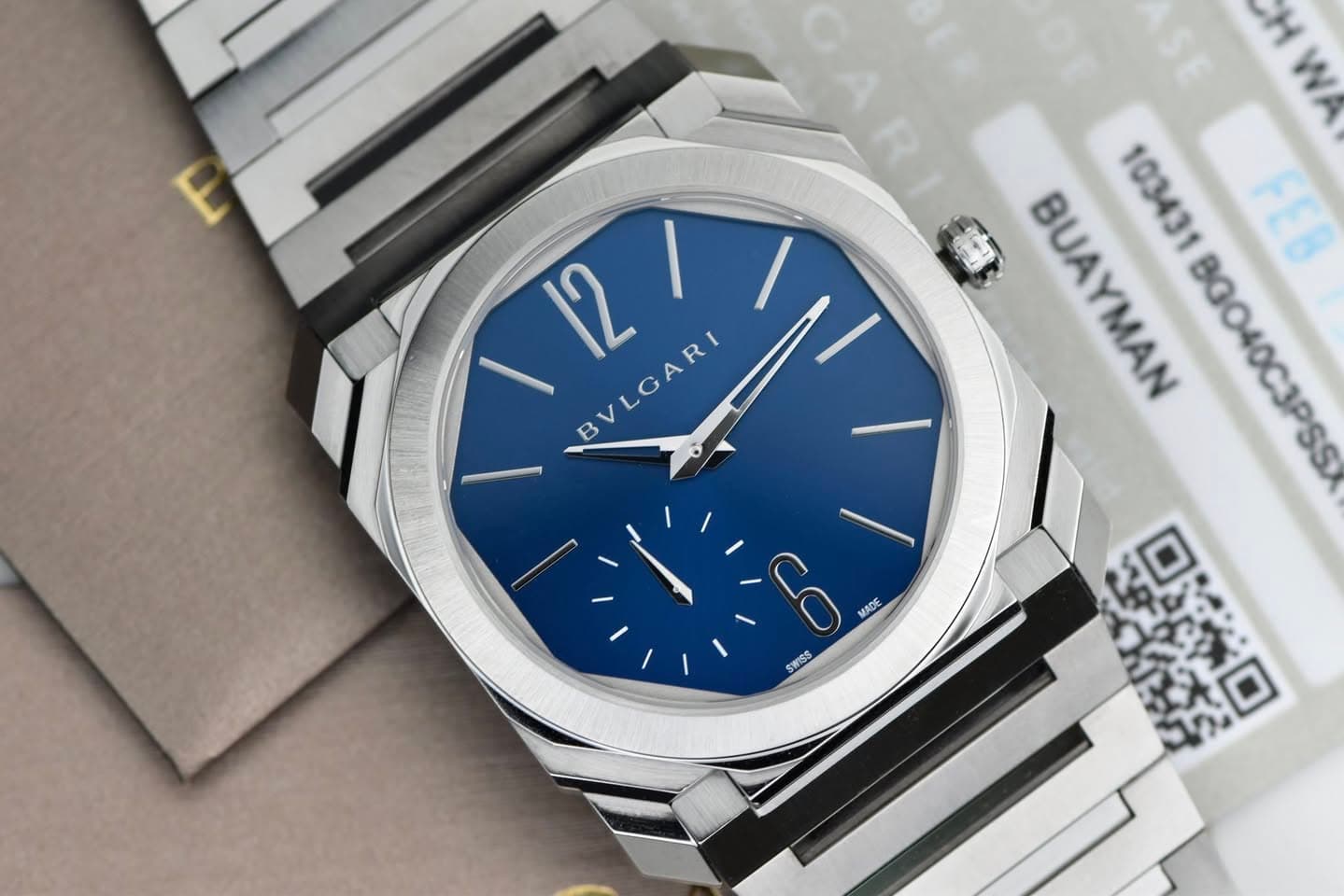 May be an image of wrist watch and text that says 'E 12 BVLGARI H W BUAYMAN 103431B0040C3PSS BGO40C3PSS BUA 103431 FEB おンサ口 ロメロ 0 MADE SWISS'