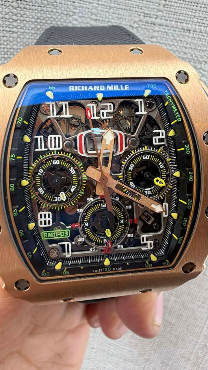 May be an image of wrist watch and text that says '65 RICHARD MILLE 70 효근 700 1 TACHYMETER ACHYMETE 근 75 75 ዜመ 60 10' 50 iIl ☬৮ s 12 1/ 10 3 9 RM11-03 گ S'