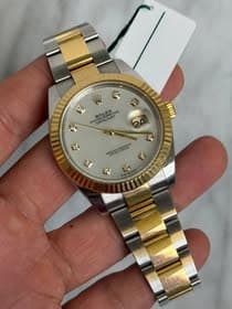 May be an image of wrist watch and text