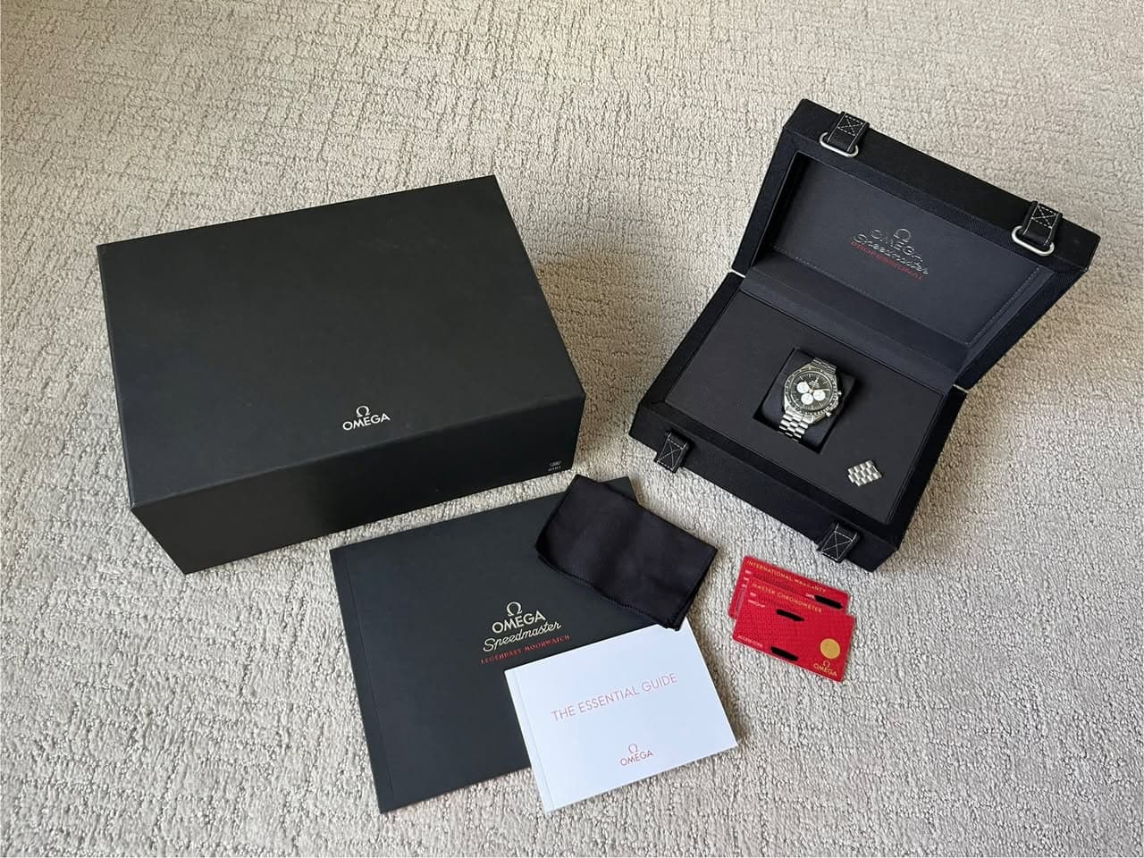May be an image of digital watch and text that says 'マン OMEGA GA OME 韓 Speedmabe Snee N OMEGA Sneedmastes MEGA 6лoB THEESSENTIALGUIDE THE ESSENTIAL GUIDE OMEGA'