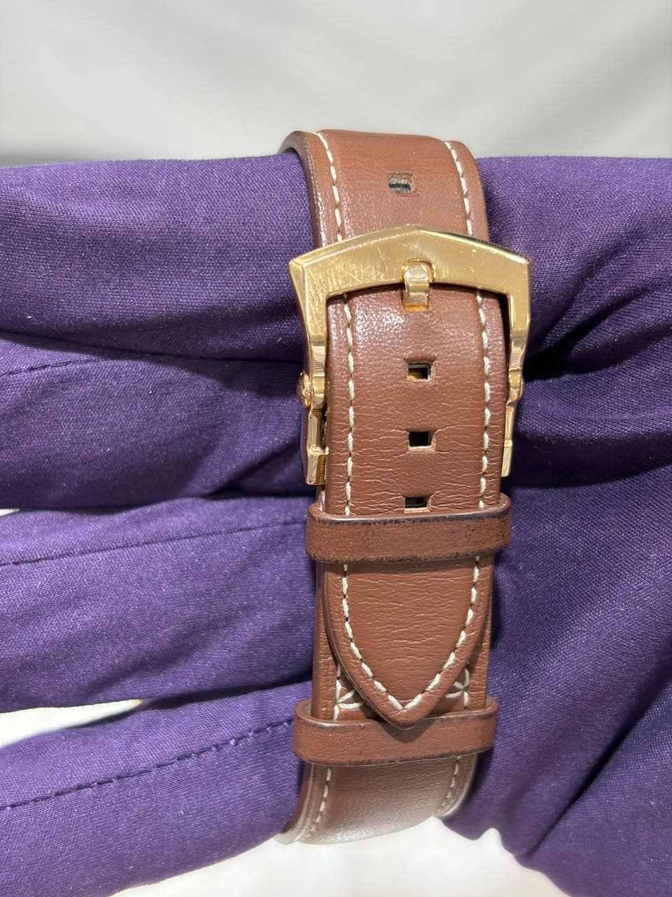 May be an image of wrist watch, saddle-stitched leather and leather