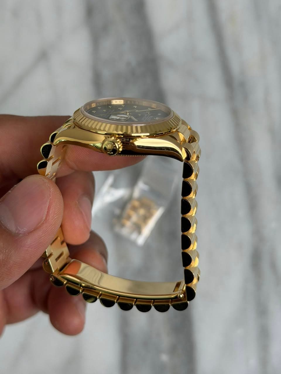 May be an image of wrist watch, jewelry and text