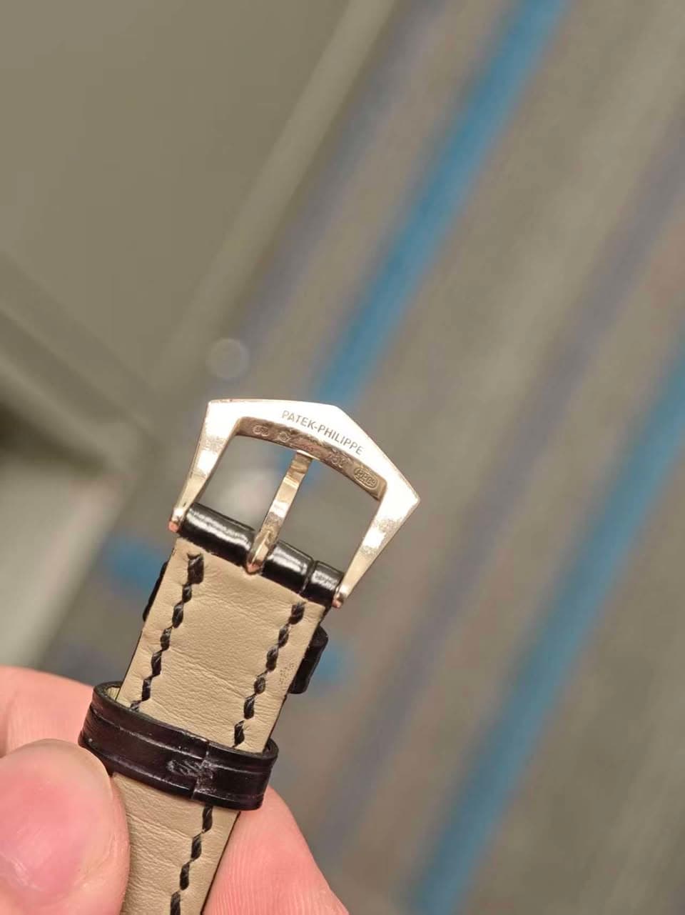 May be an image of wrist watch and saddle-stitched leather