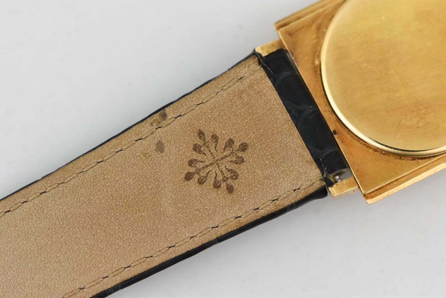 May be an image of wrist watch and brass