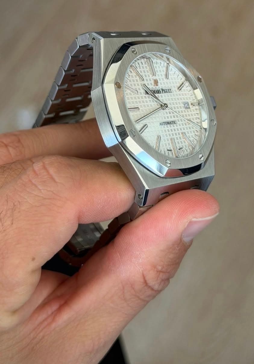 May be an image of wrist watch and text